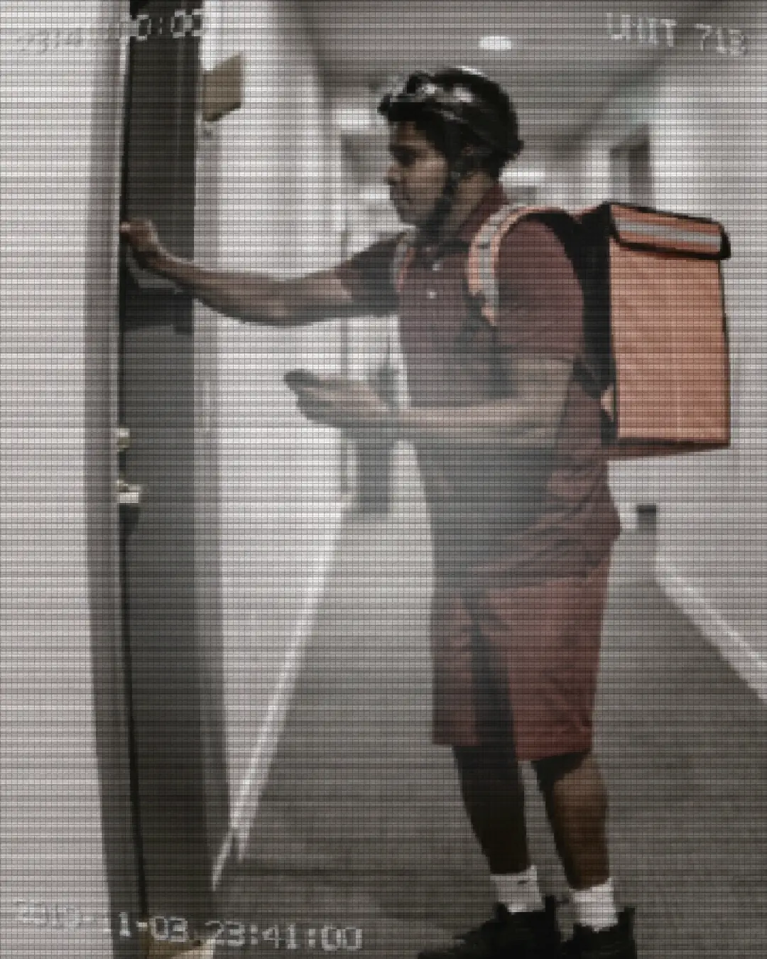 A courier at the door caught on IR security-camera footage — Night-IR