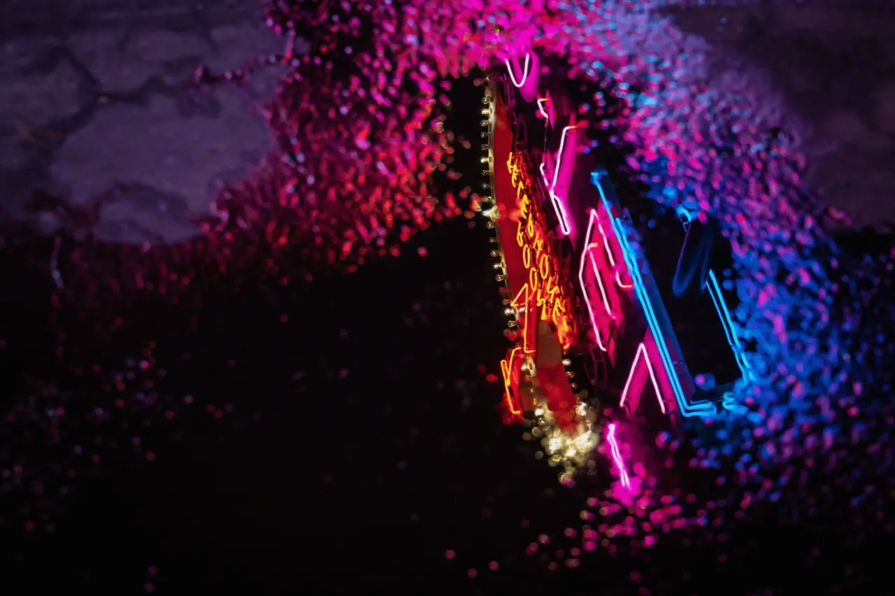 Neon reflected in a rain puddle on a PVM broadcast monitor — PVM / BVM